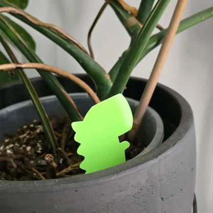 Potted plant with a green leaf-shaped plant marker
