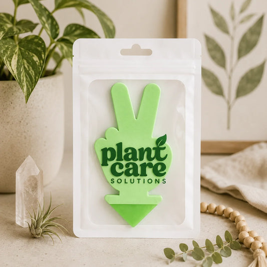 Green 'plant care solutions' product in packaging with plants and crystals in the background